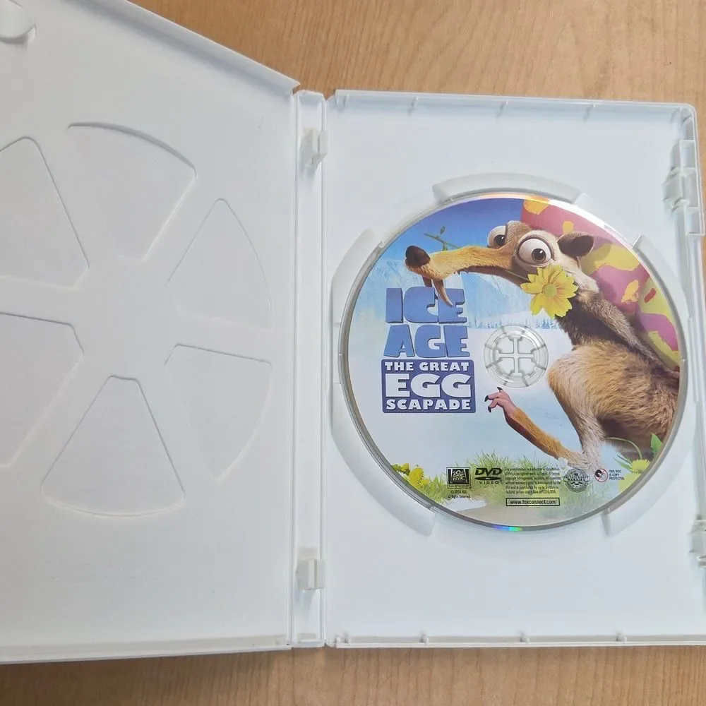 collection of Ice Age merchandise, including a VHS tape, two DVDs, Sid the Sloth